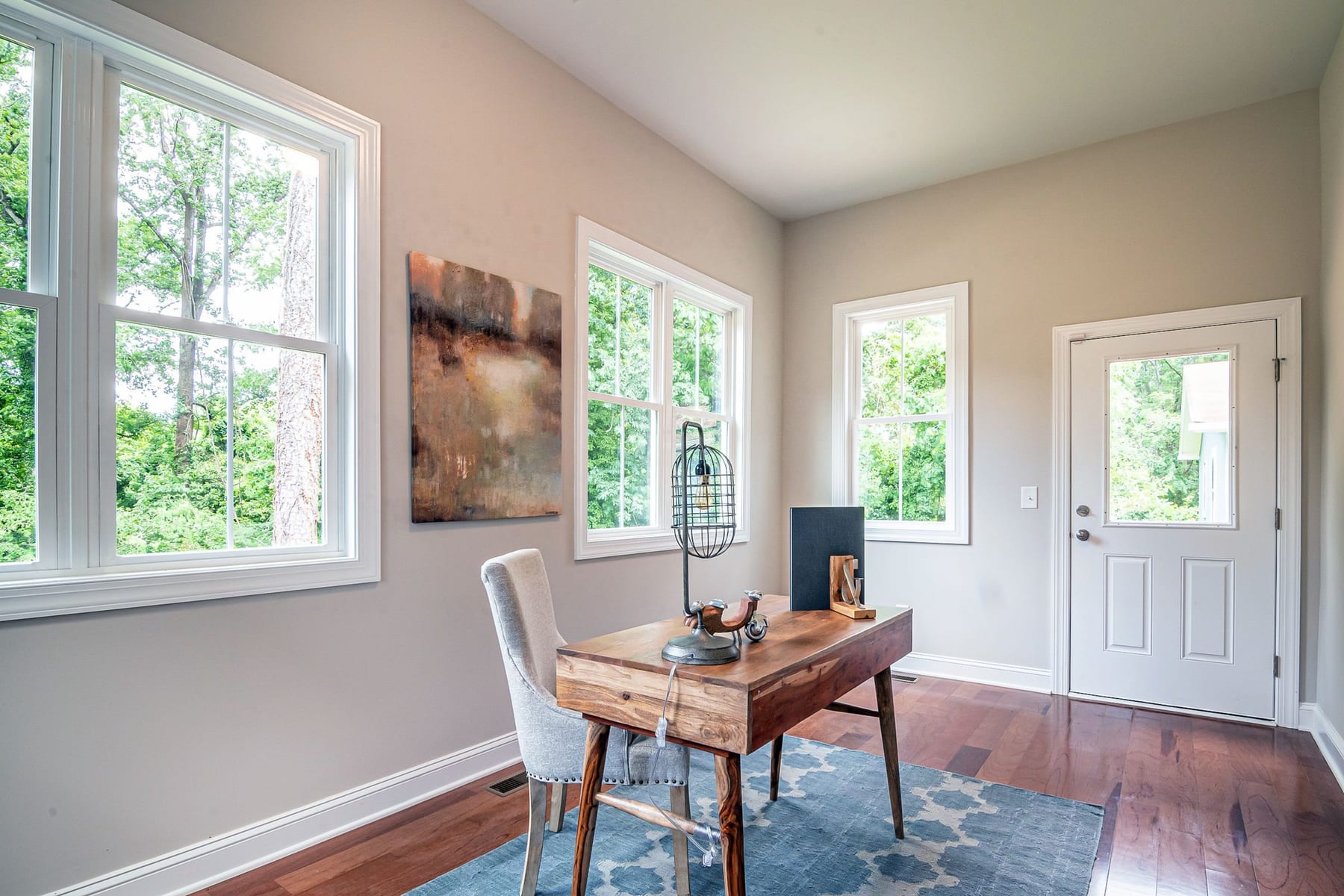 Private office with a live-edge wood desk, three windows and its own door